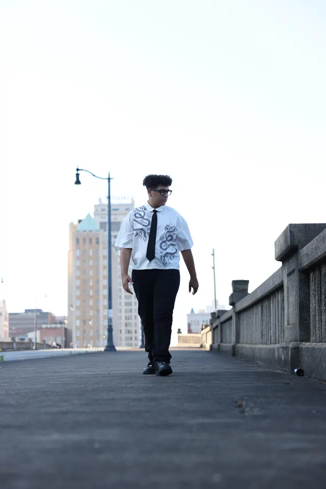 Will Smith walking down an elevated walkway toward the camera